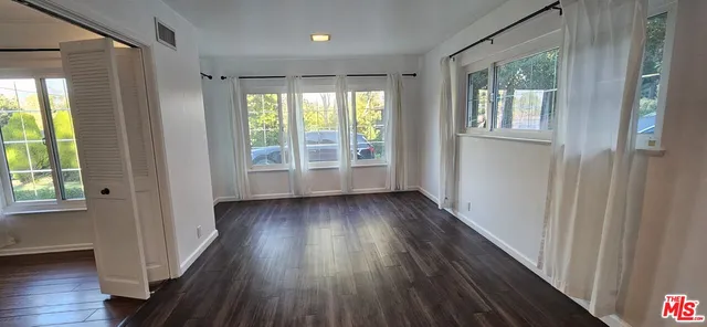 a view of hallway with wooden floor and stairs