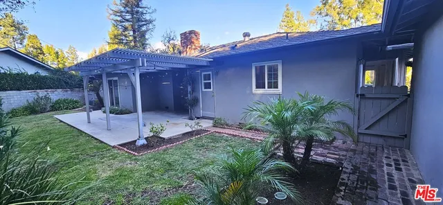 a view of a hallway with wooden floor and a living room