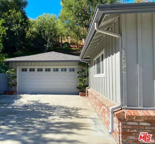an aerial view of a house with a yard and lake view
