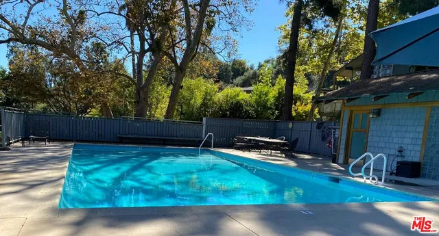 an aerial view of a house with a yard and tennis court