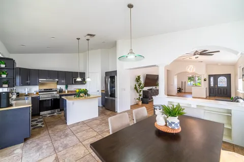 a kitchen with a dining table cabinets and stainless steel appliances
