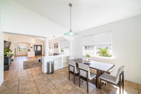 a dining room with furniture and a chandelier