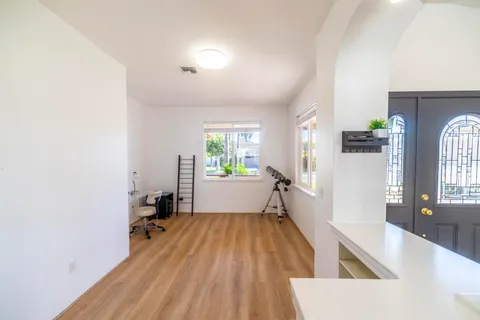 a view of a living room with a wooden floor