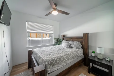 a bedroom with a bed and a window