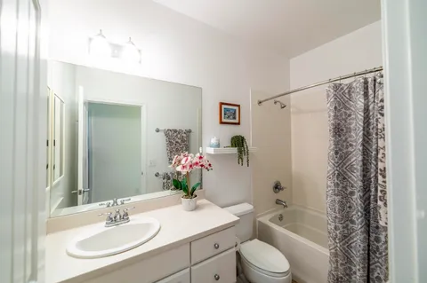 a bathroom with a sink toilet tub and shower