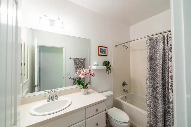 a bathroom with a sink toilet tub and shower