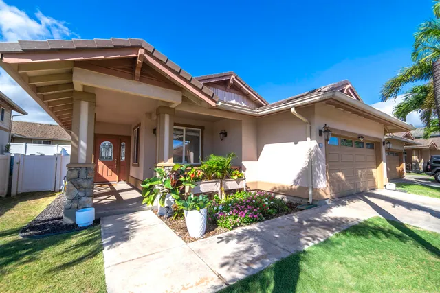 a front view of a house with garden