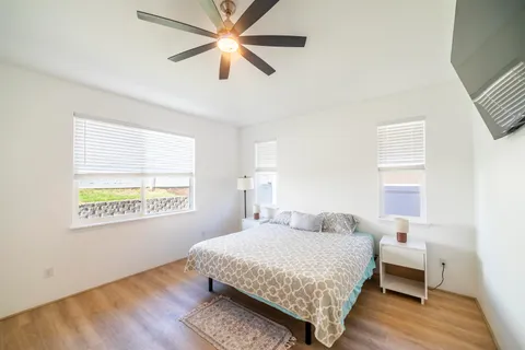 a bedroom with a bed and wooden floor