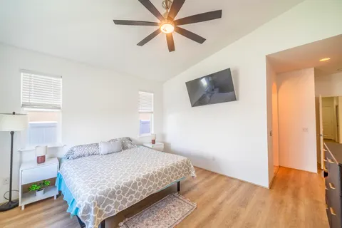 a bedroom with a bed and a flat screen tv