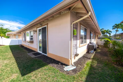 a view of house with a yard