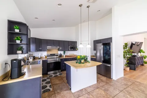 a kitchen with refrigerator and cabinets
