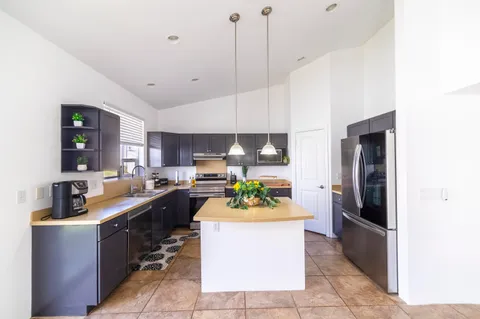 a kitchen with a sink counter top space and stainless steel appliances