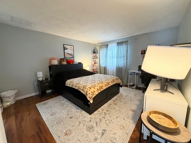 a bedroom with a bed window and a table