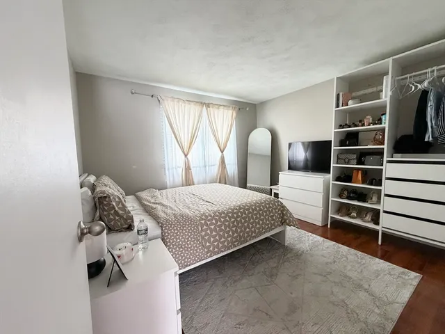 a bedroom with a bed and walk in closet