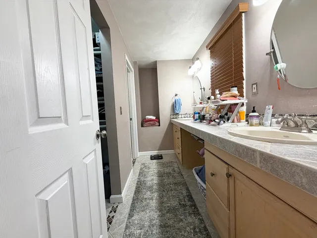 a bathroom with a double vanity sink and a mirror