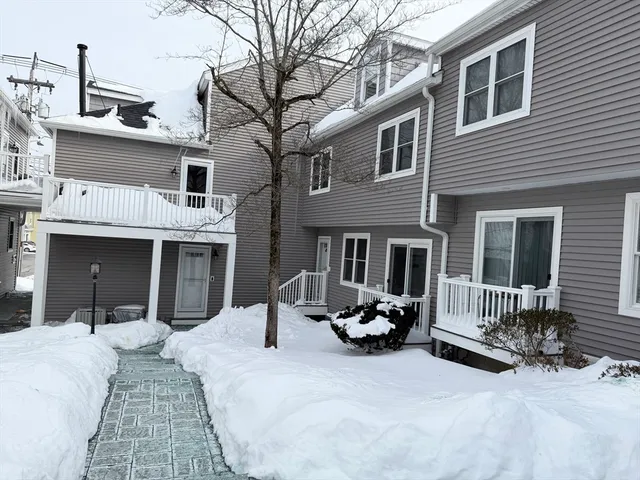a view of a house with a yard and seating space