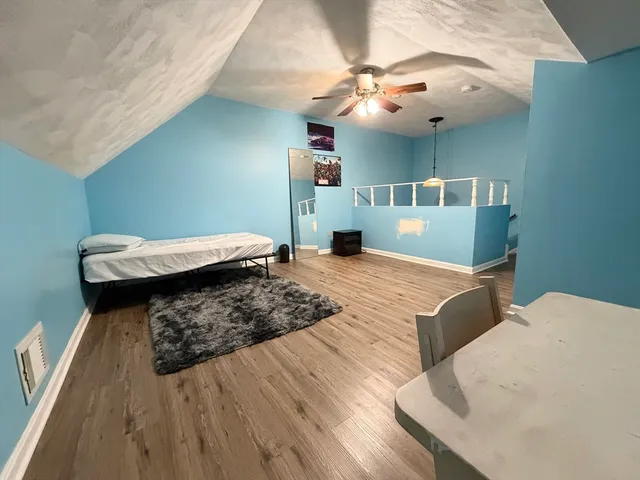 a bedroom with a bed and a chandelier