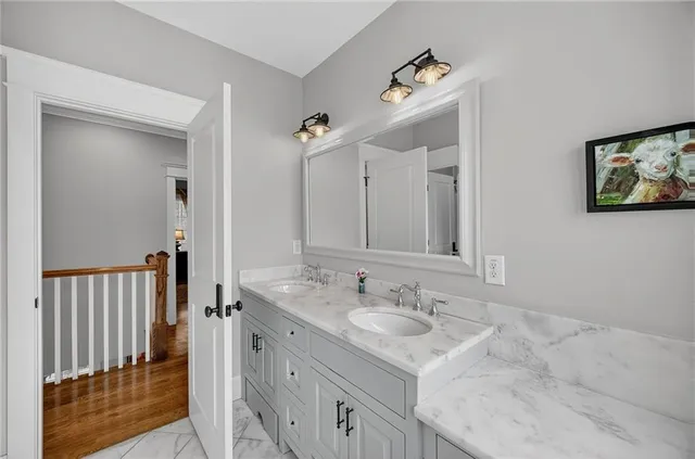 a hallway with a sink and a mirror