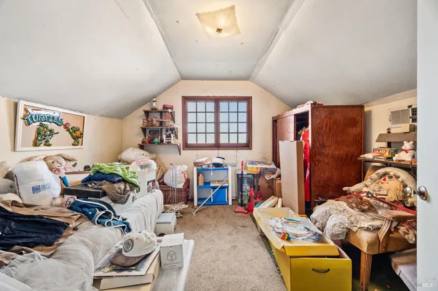 a bedroom with furniture and a window