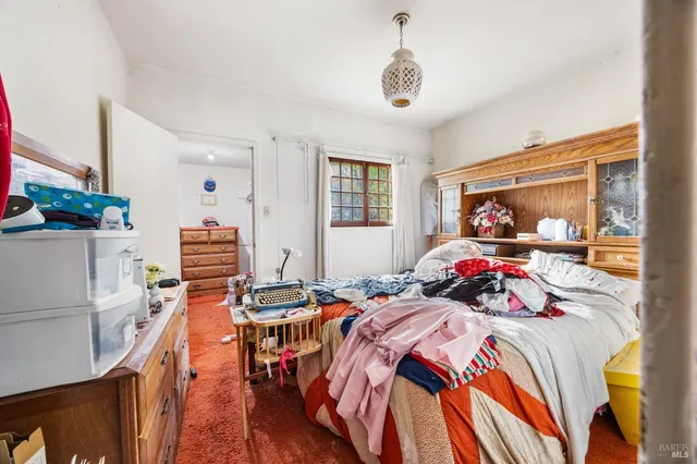 a bed room with a bed and a chair