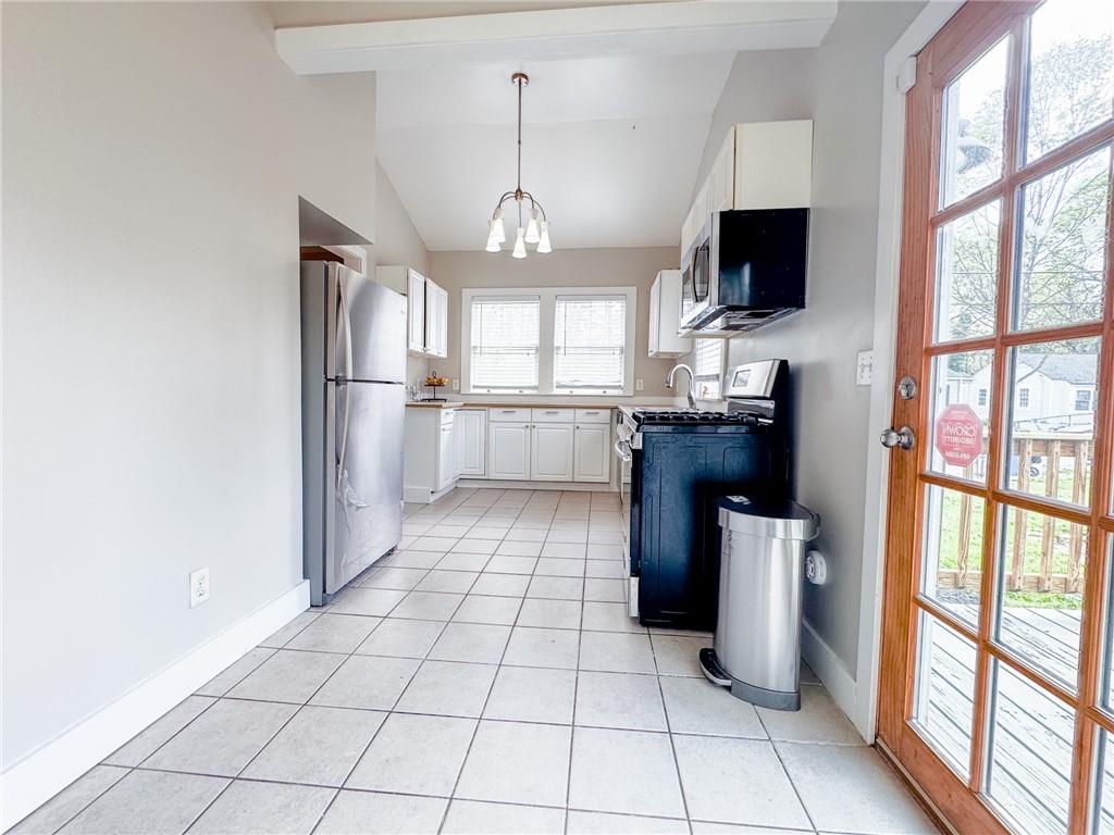 1735 Spring Avenue East Point, GA 30344 - Photo 5 of 9 a kitchen with stainless steel appliances a stove refrigerator sink and microwave