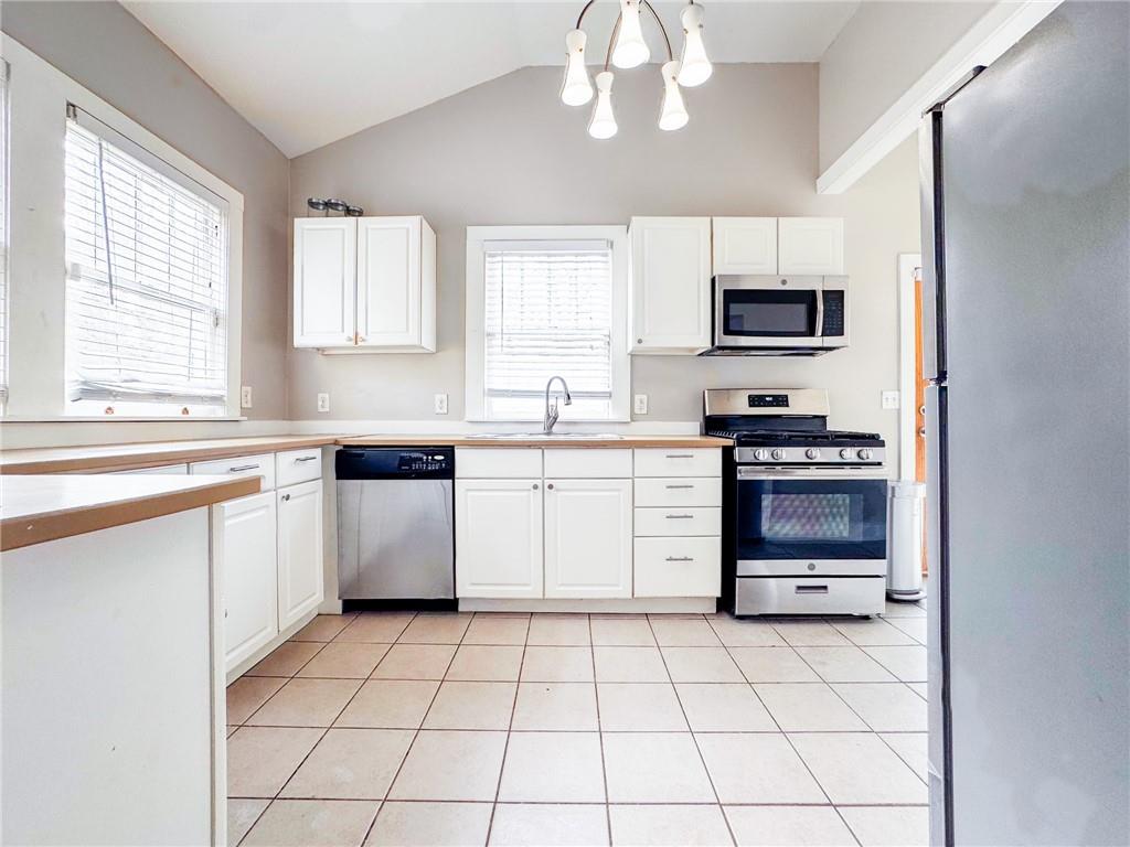 1735 Spring Avenue East Point, GA 30344 - Photo 6 of 9 a kitchen with stainless steel appliances a sink a stove a microwave and cabinets