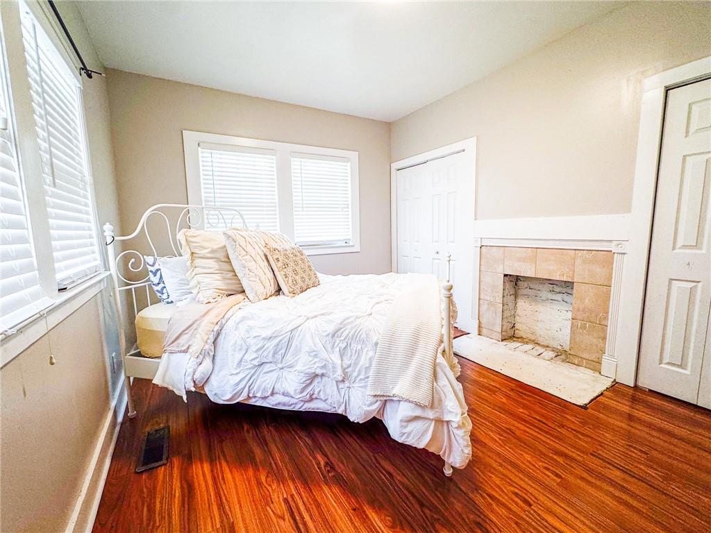 1735 Spring Avenue East Point, GA 30344 - Photo 8 of 9 a bedroom with a bed and a fireplace
