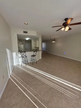 a view of a livingroom with chairs and table