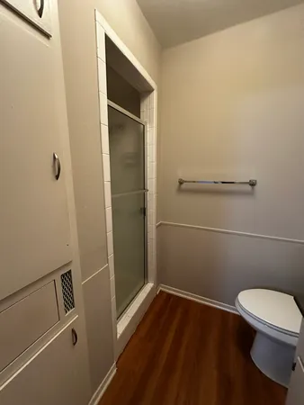 a bathroom with a toilet and a shower