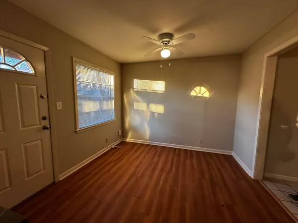 wooden floor in an empty room with a window