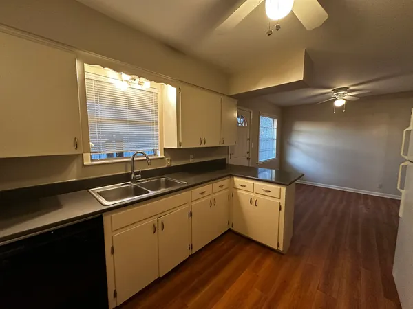 a kitchen with a sink cabinets and window