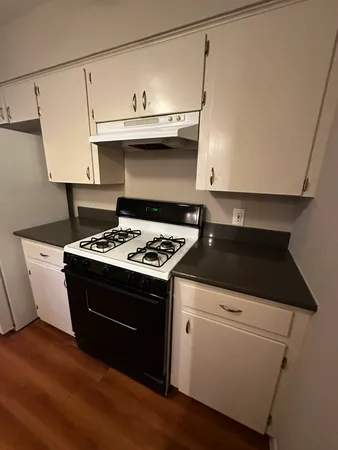 a stove top oven sitting inside of a kitchen