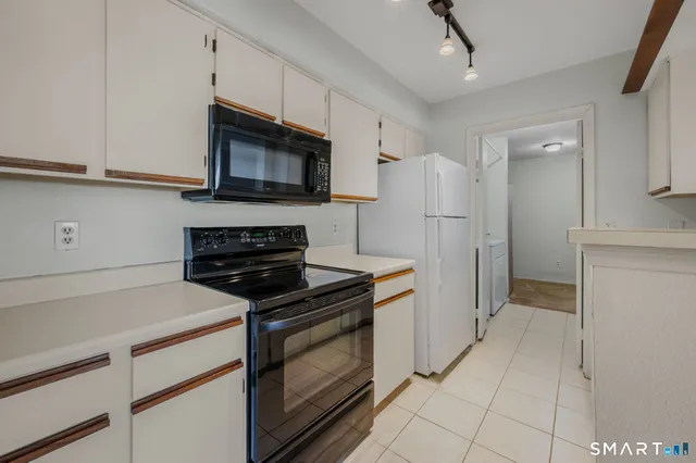 a kitchen with a refrigerator stove and microwave