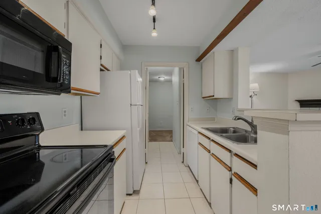 a kitchen with a sink stove and microwave