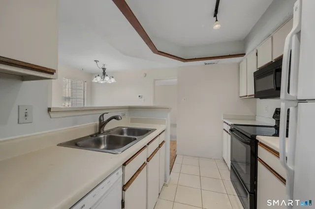 a kitchen that has a sink and a stove