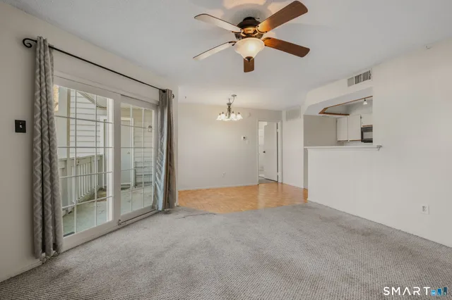 a view of empty room with ceiling fan