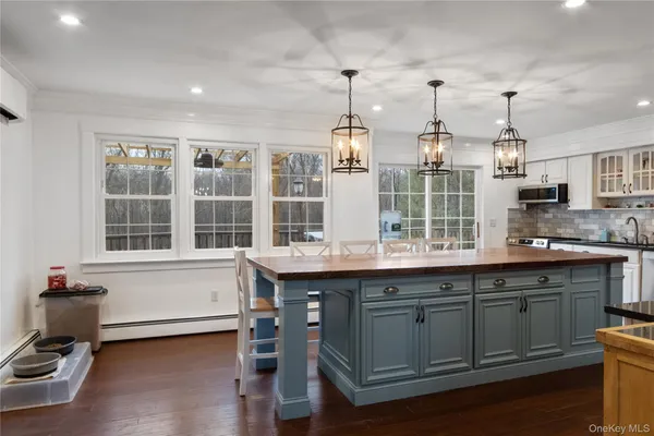 a kitchen with a sink window and cabinets