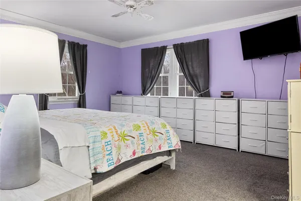 a bedroom with a bed and flat screen tv