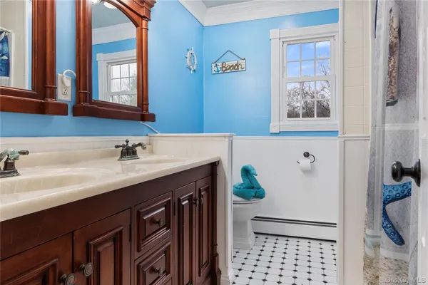 a bathroom with a sink a mirror and a window