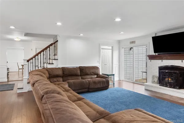 a living room with furniture flat screen tv and a fireplace