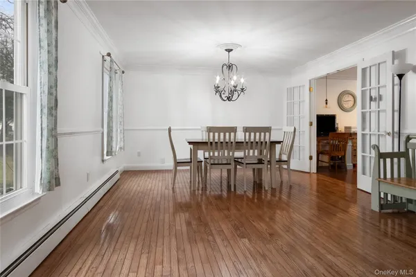 an view of a dining room with furniture and wooden floor