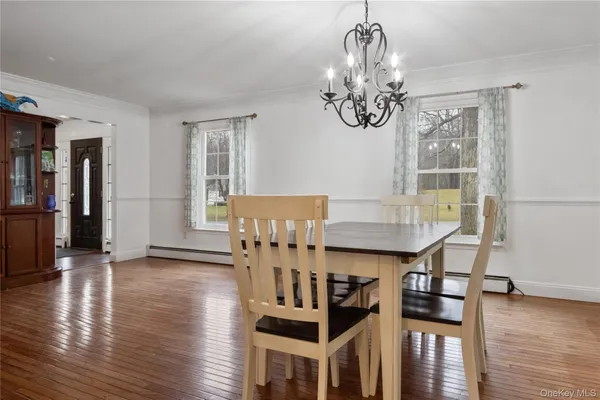 a view of a dining room with furniture wooden floor and chandelier