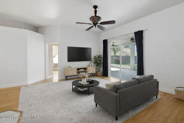 a living room with furniture and a flat screen tv
