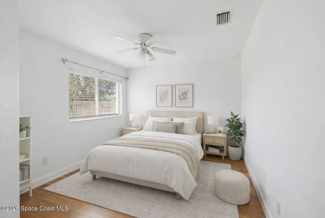 a bedroom with a bed lamp and a window
