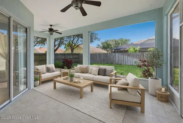 a living room with furniture and a floor to ceiling window