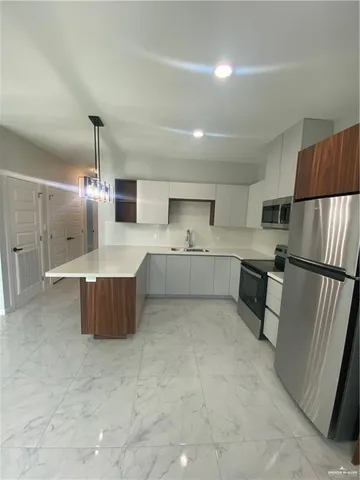 a large kitchen with a large window