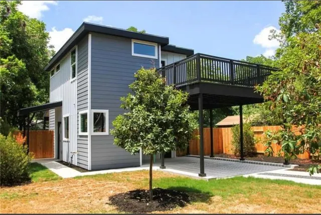 a backyard of a house with table and chairs