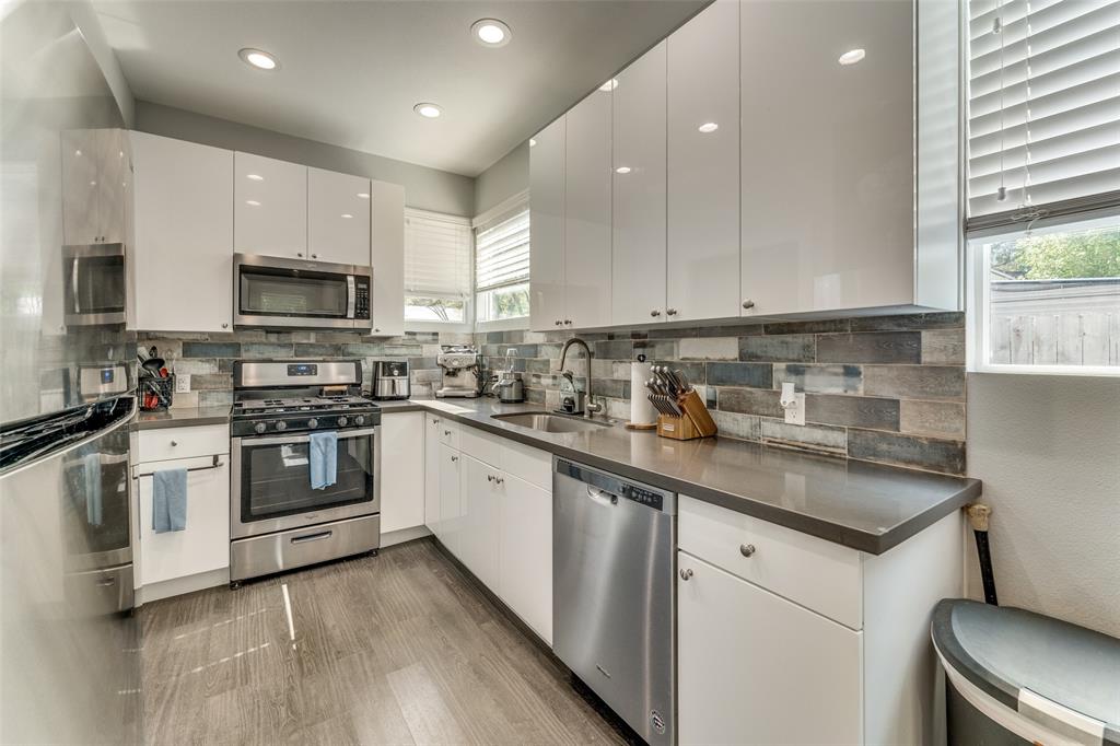 4709 Prock Lane, Unit B Austin, TX 78721 - Photo 4 of 17 a kitchen with stainless steel appliances granite countertop a stove a sink and a microwave