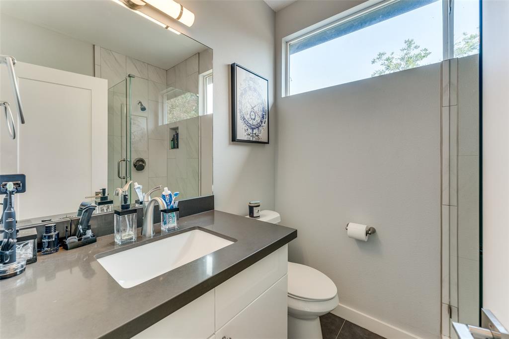 4709 Prock Lane, Unit B Austin, TX 78721 - Photo 8 of 17 a bathroom with a sink a toilet a mirror and shower