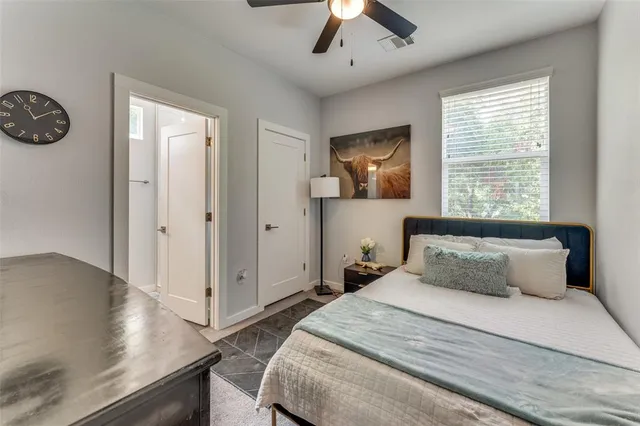 a bedroom with a bed and a window